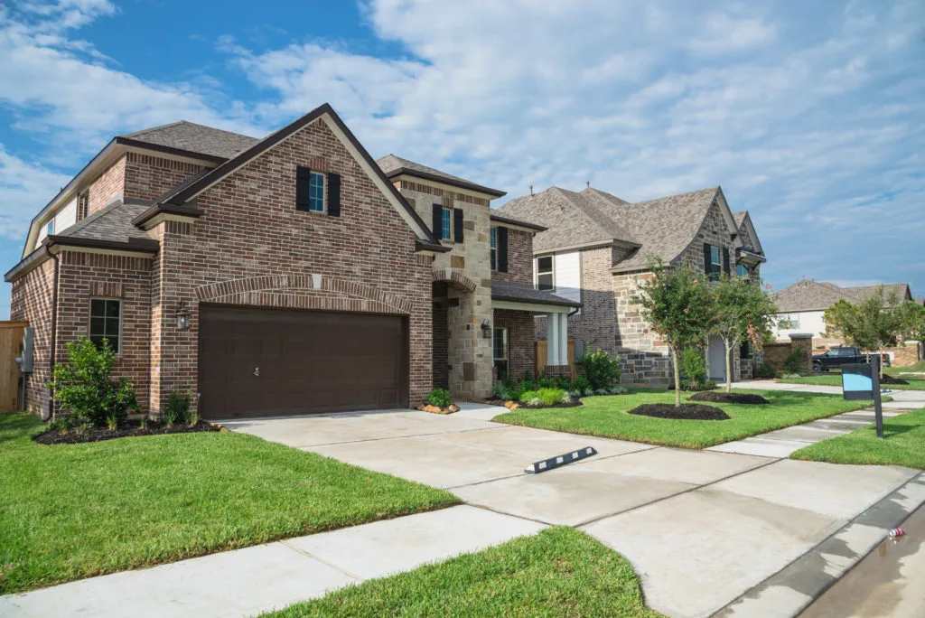 A beautiful two-story brick home in Tyler, TX, showcasing the type of property you can find with a knowledgeable Realtor in Tyler.